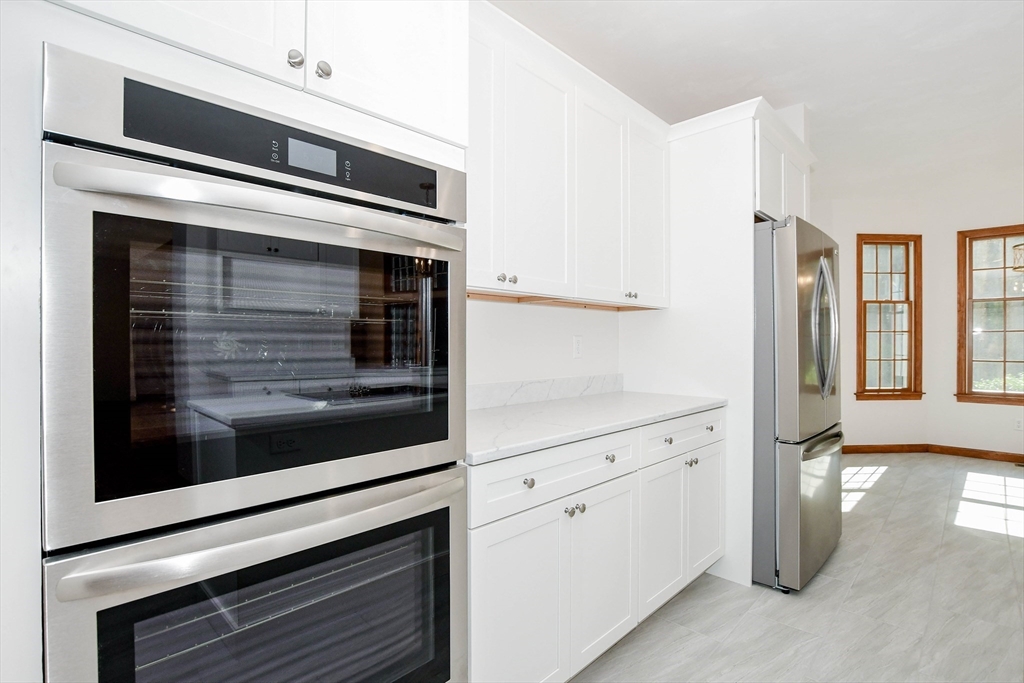 7 Upland Way Marion, MA 02738 - Photo 14 of 42 a kitchen with windows and white cabinets