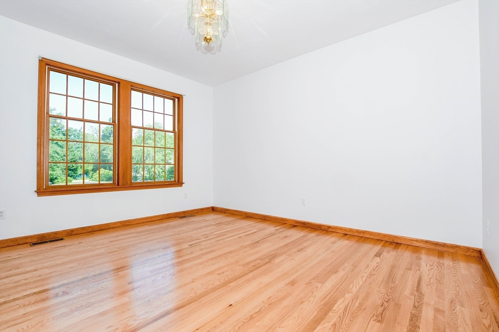7 Upland Way Marion, MA 02738 - Photo 16 of 42 an empty room with wooden floor and windows