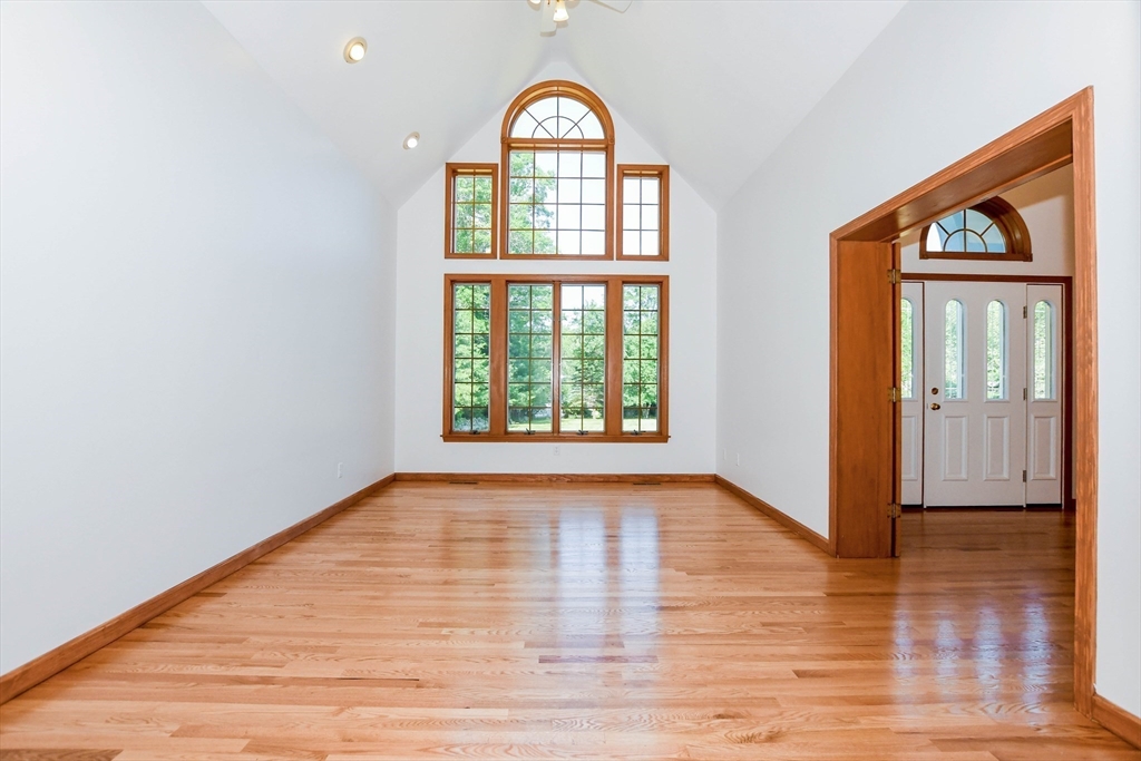 7 Upland Way Marion, MA 02738 - Photo 18 of 42 a view of an empty room with wooden floor and a window