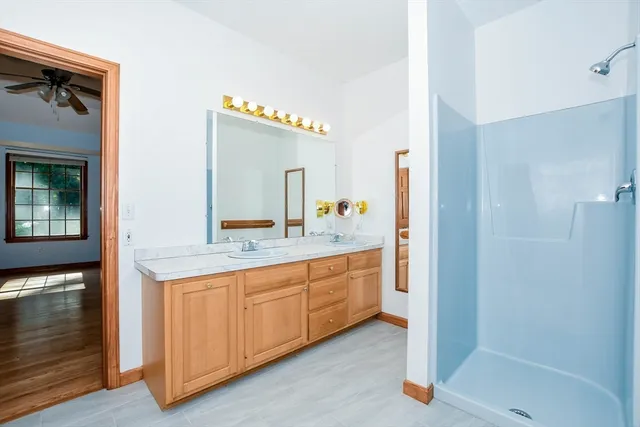 a bathroom with a double vanity sink and a mirror