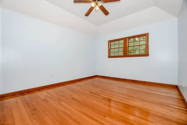 a view of an empty room with a ceiling fan