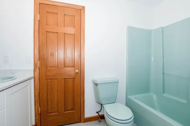 a white toilet sitting next to a bathroom sink