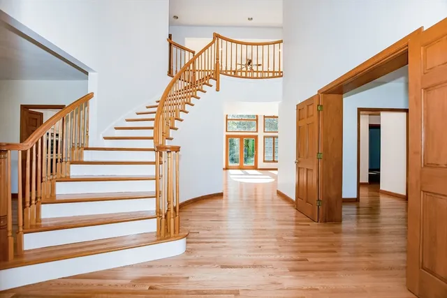 a view of entryway with wooden floor and stairs