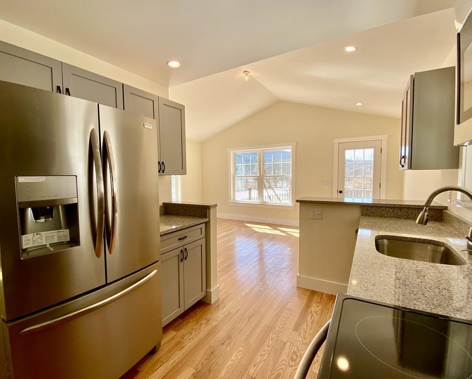 309 Main Road Colrain, MA 01340 - Photo 3 of 24 a kitchen with stainless steel appliances granite countertop a refrigerator a sink and a stove