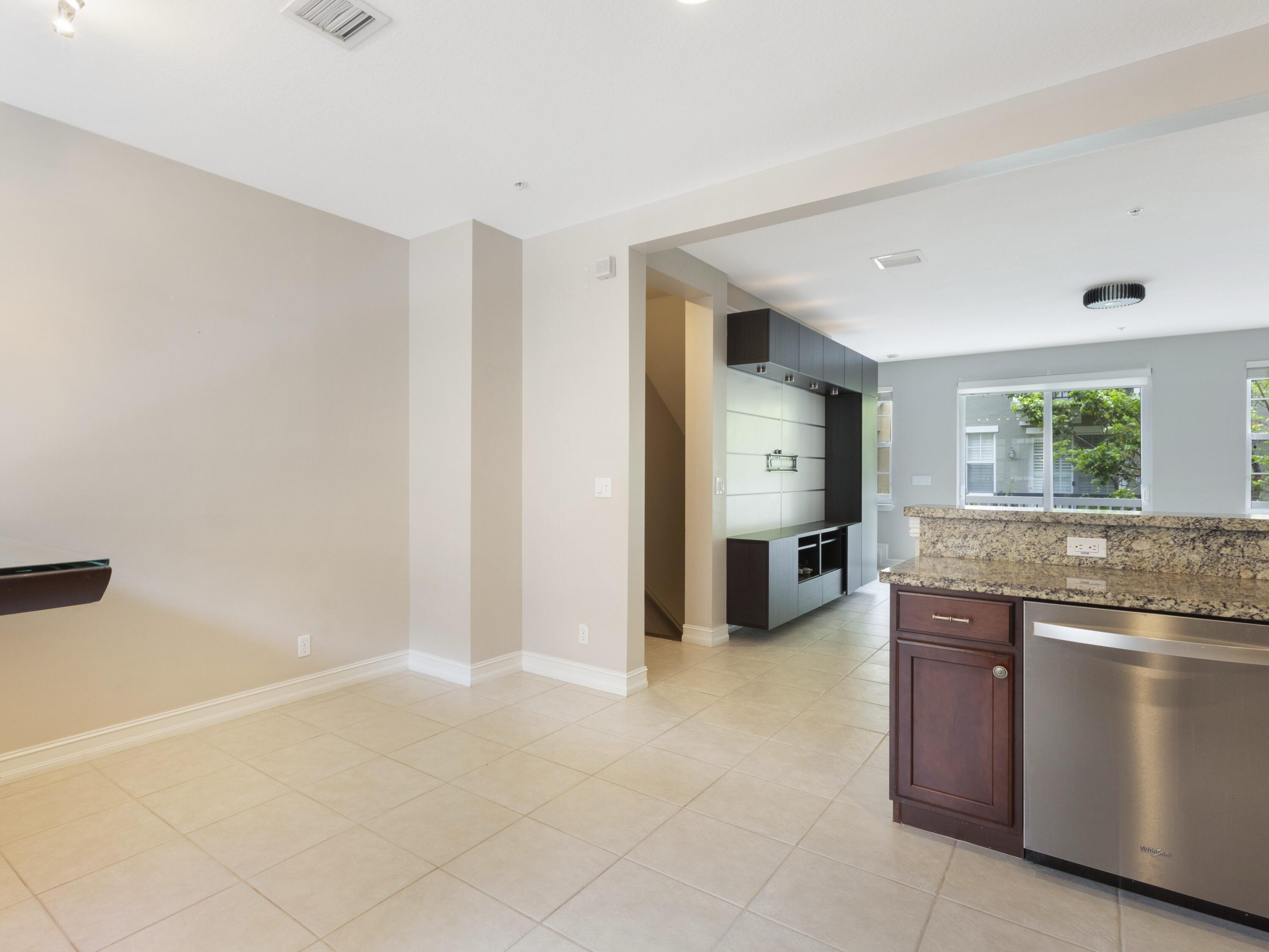 110 West Coda Circle, Unit 110 Delray Beach, FL 33444 - Photo 21 of 42 a view of a kitchen with a sink and dishwasher a stove top oven with wooden floor