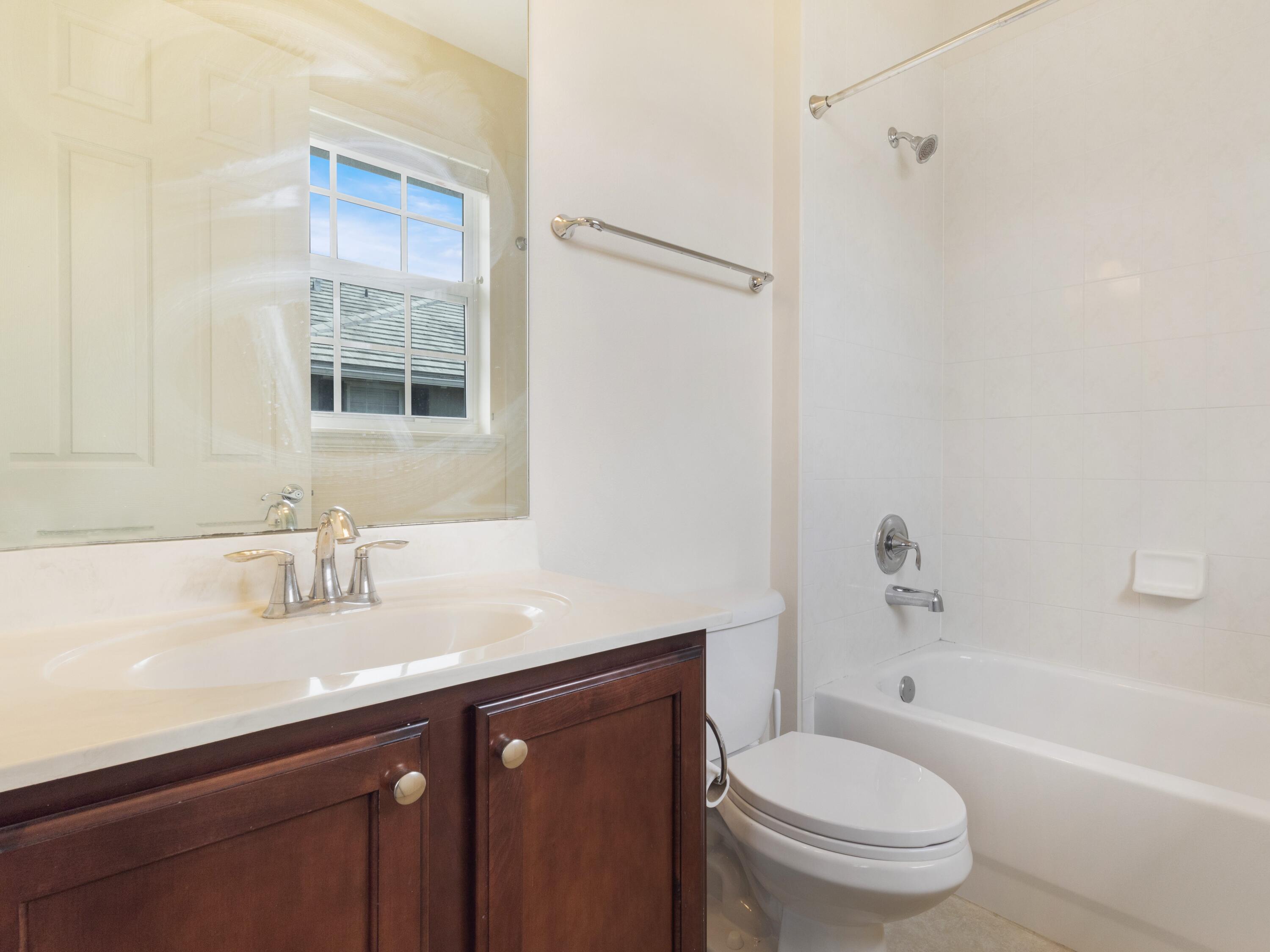 110 West Coda Circle, Unit 110 Delray Beach, FL 33444 - Photo 25 of 42 a bathroom with a sink toilet vanity and shower