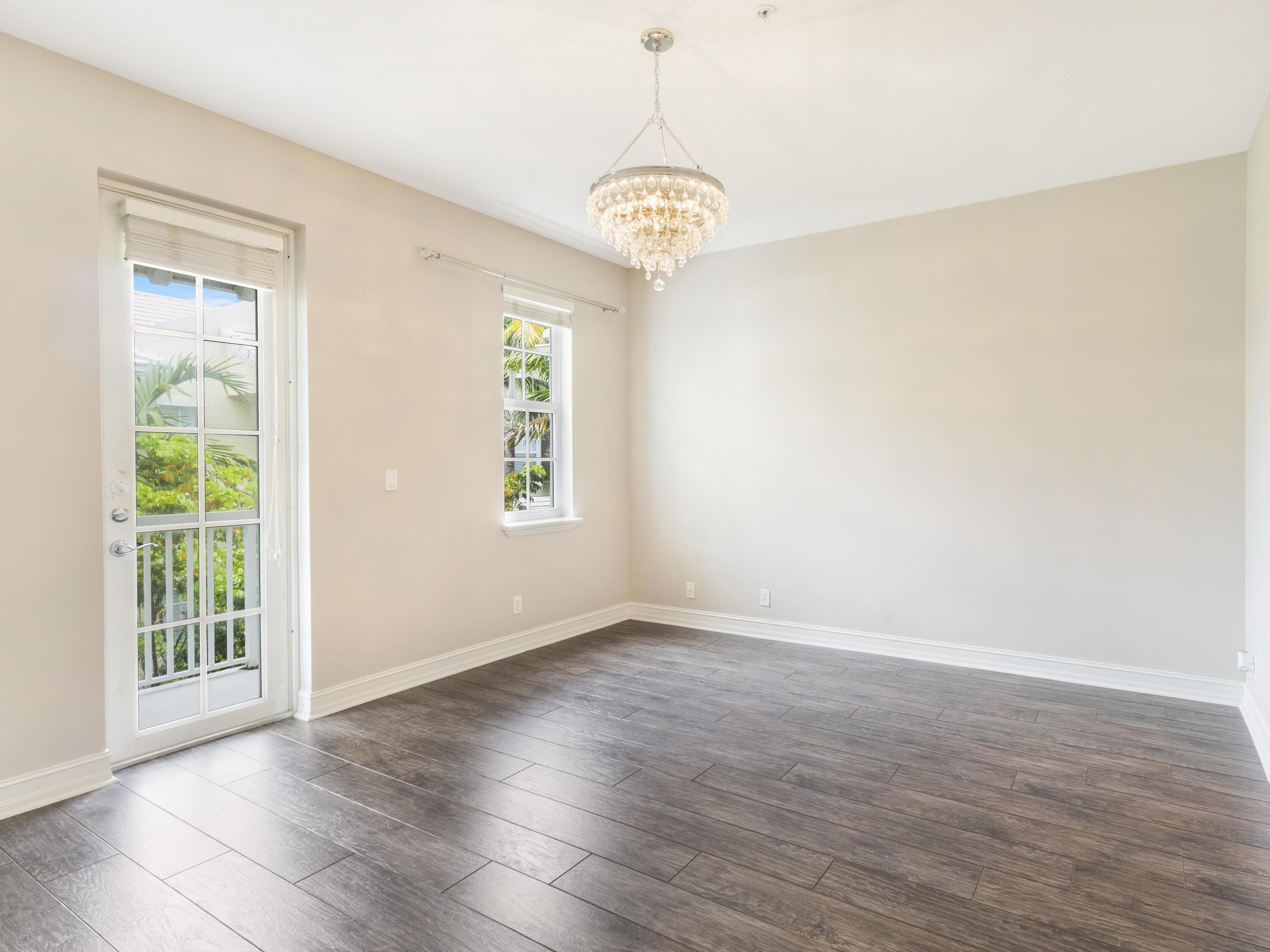 110 West Coda Circle, Unit 110 Delray Beach, FL 33444 - Photo 28 of 42 a view of an empty room with wooden floor and a window
