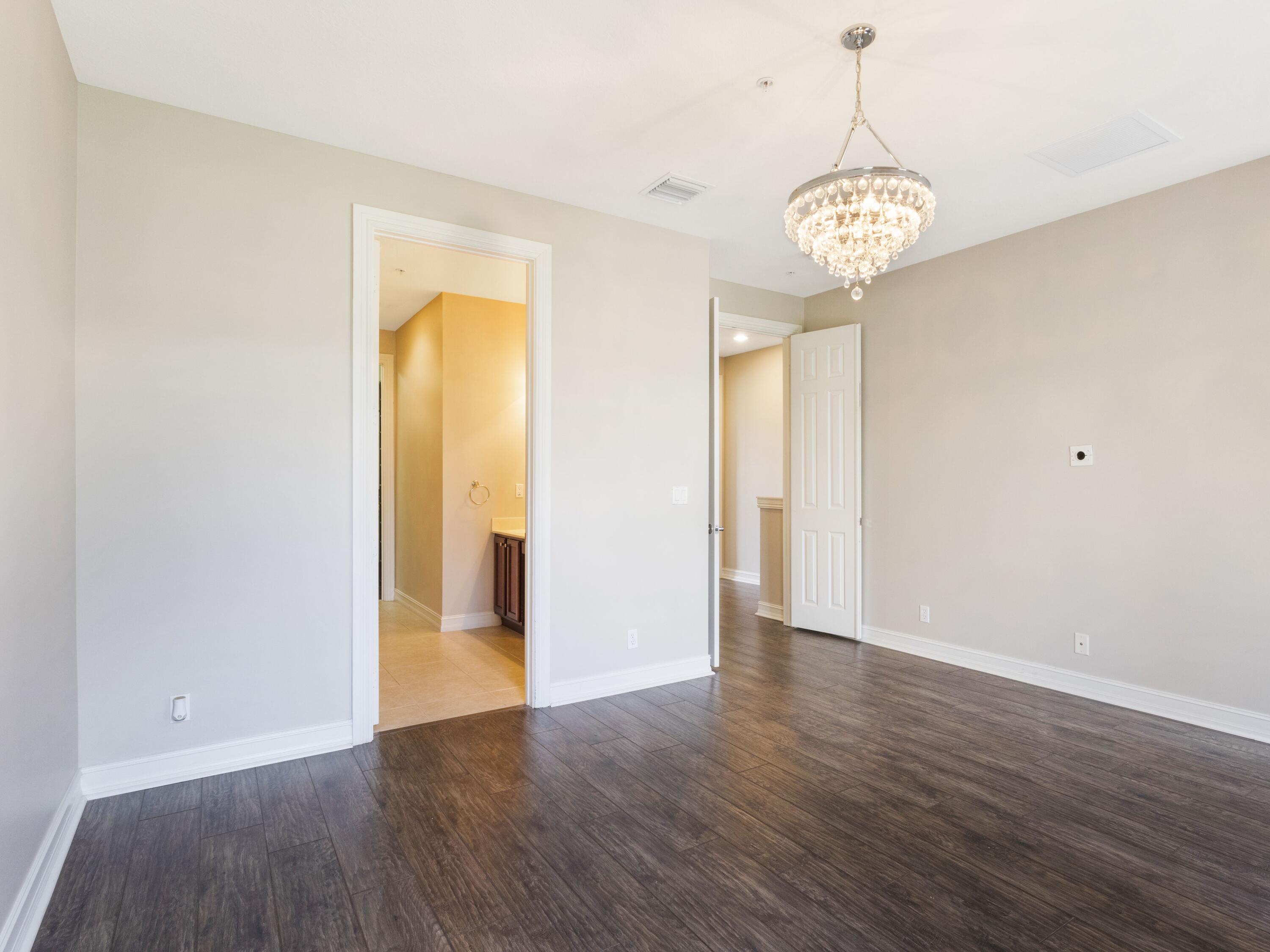 110 West Coda Circle, Unit 110 Delray Beach, FL 33444 - Photo 29 of 42 an empty room with wooden floor and a window