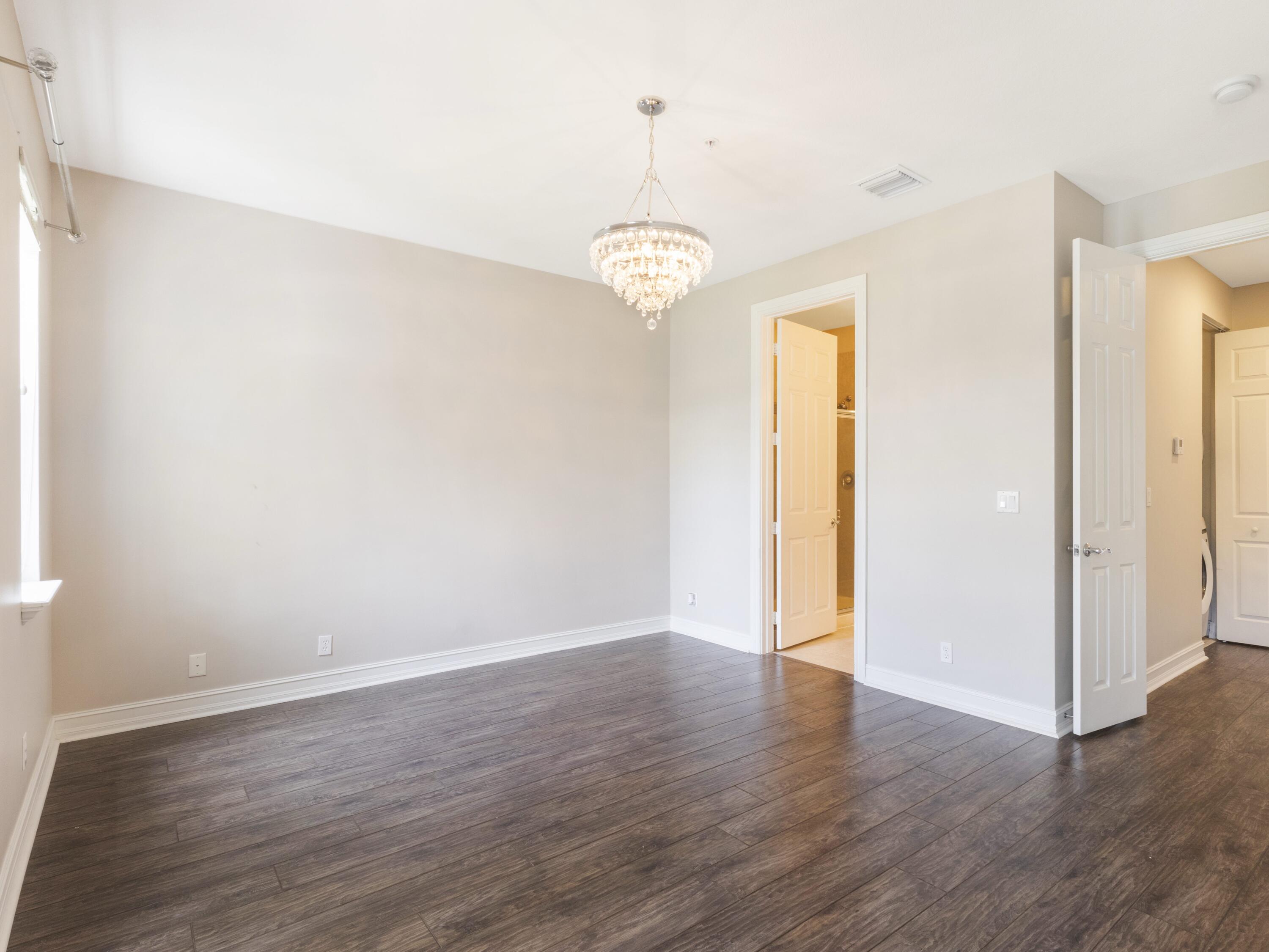 110 West Coda Circle, Unit 110 Delray Beach, FL 33444 - Photo 30 of 42 an empty room with wooden floor fan and window