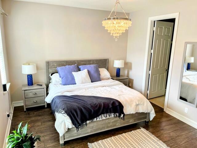 110 West Coda Circle, Unit 110 Delray Beach, FL 33444 - Photo 31 of 42 a bedroom with a bed and wooden floor