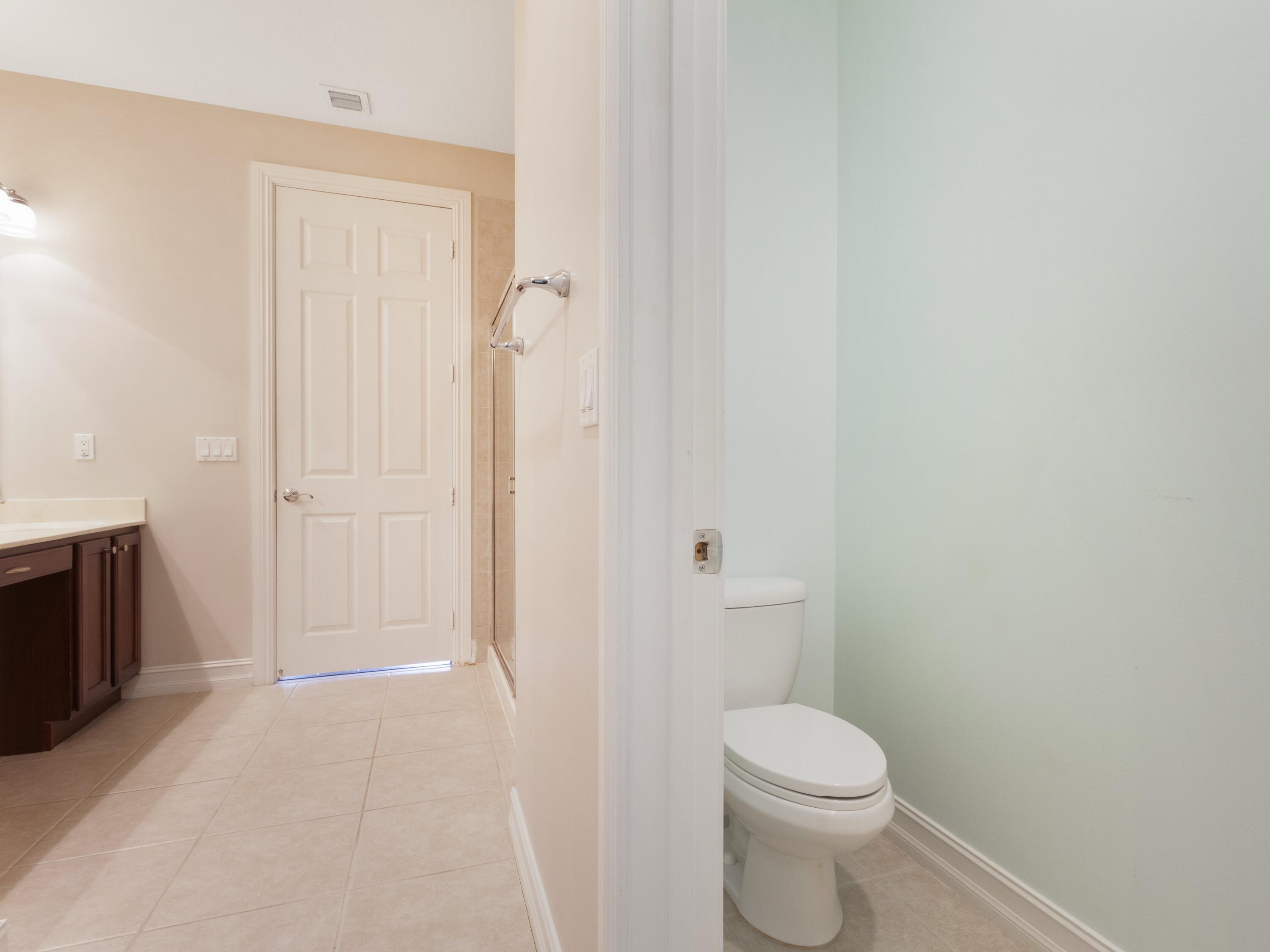 110 West Coda Circle, Unit 110 Delray Beach, FL 33444 - Photo 34 of 42 a bathroom with a toilet and a shower