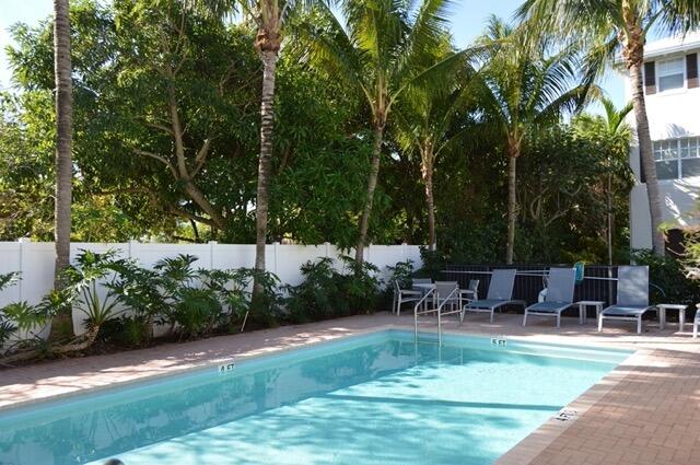 110 West Coda Circle, Unit 110 Delray Beach, FL 33444 - Photo 38 of 42 a view of a table and chairs in the garden