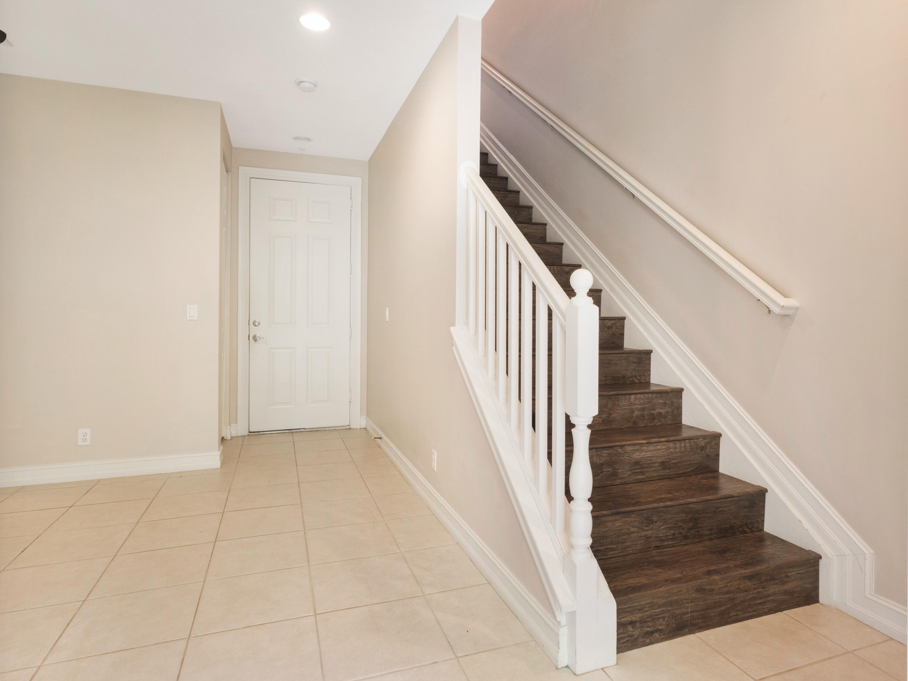 110 West Coda Circle, Unit 110 Delray Beach, FL 33444 - Photo 10 of 42 a view of staircase with white walls and white walls