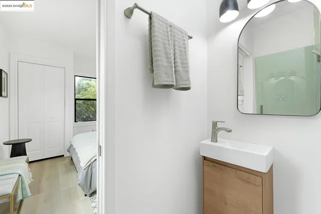 a en suite bathroom with a sink mirror and vanity