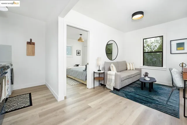a living room with furniture wooden floor and a large window