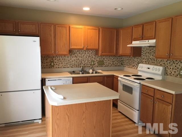 3645 Bison Hill Lane Raleigh, NC 27604 - Photo 4 of 9 a kitchen with a sink a stove and a refrigerator