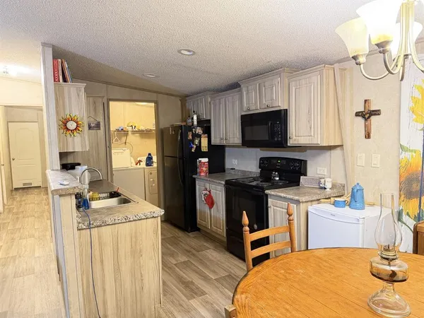 a kitchen with a refrigerator stove top oven and sink