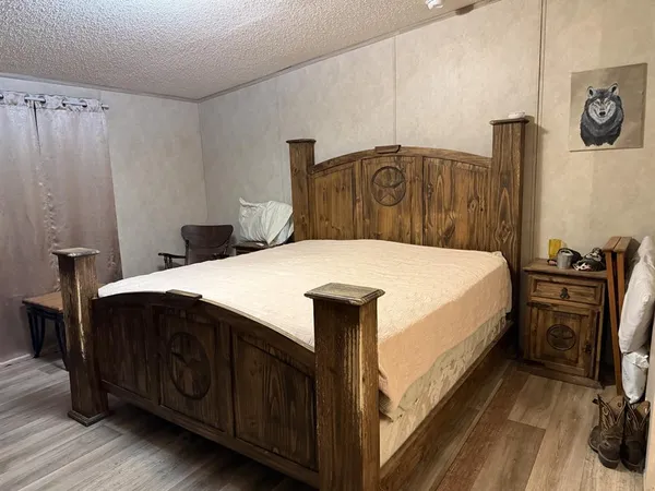a bedroom with a bed and a tv