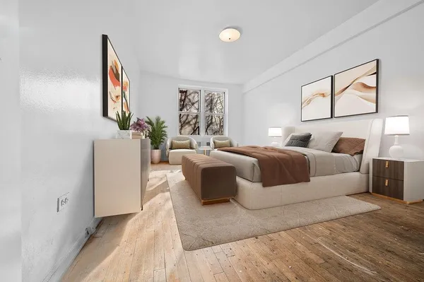 a bedroom with a large bed and a window