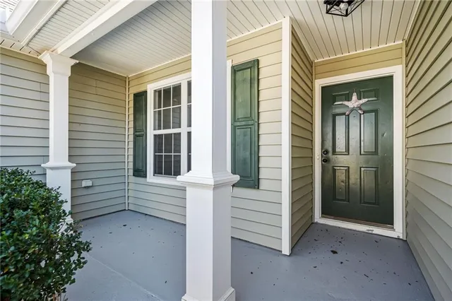 a view of an empty room with a fireplace and a window