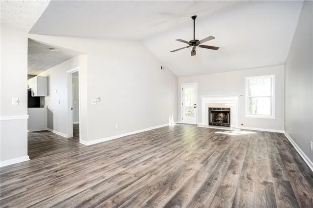 a kitchen with granite countertop a sink cabinets and stainless steel appliances