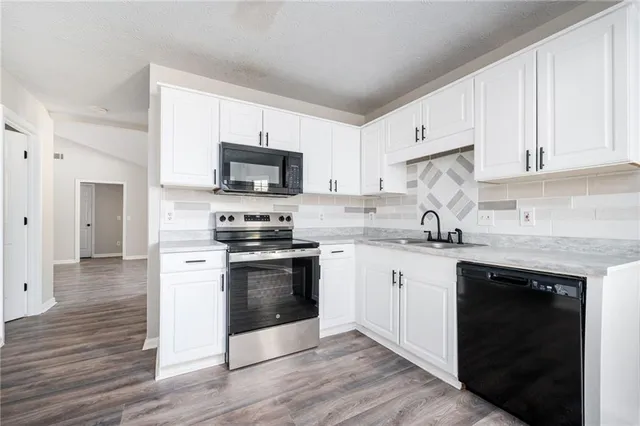 a kitchen with a refrigerator stove and microwave