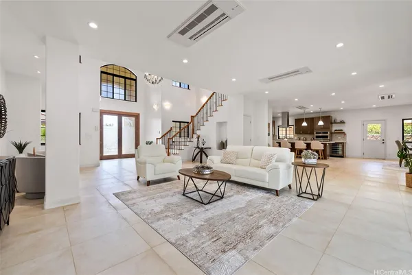 a living room with furniture and kitchen view