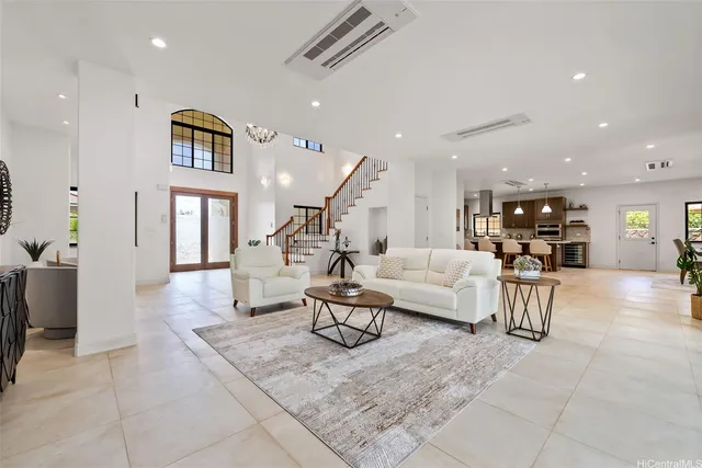 a living room with furniture and kitchen view