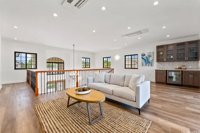 a living room with furniture and a wooden floor