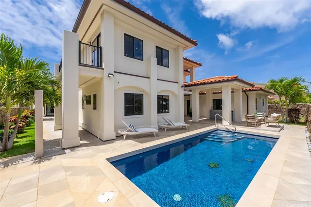 a view of a house with backyard and sitting area