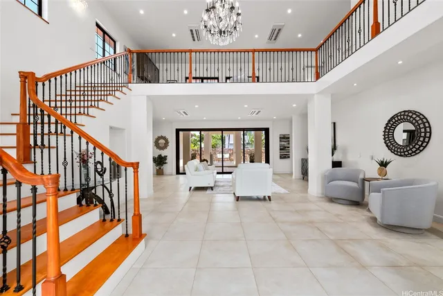 a hall way with furniture and a large window