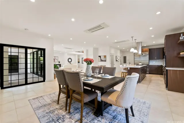 a dining room with furniture and a floor to ceiling window