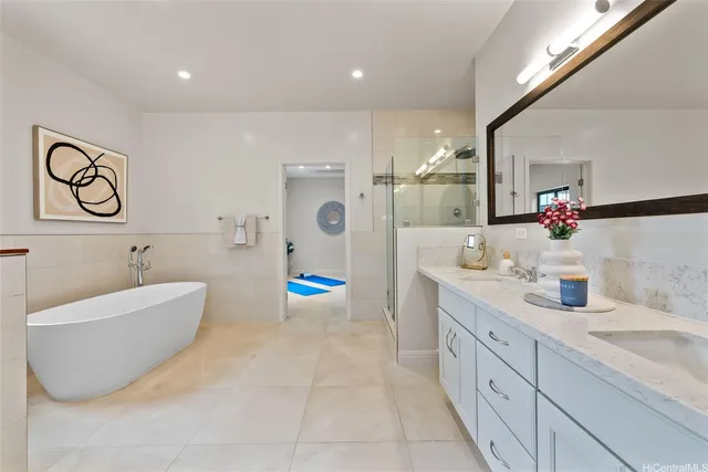 a bathroom with a tub sink and mirror