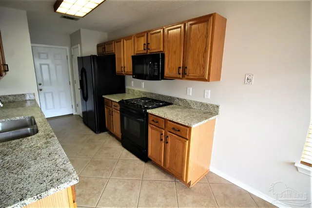 a kitchen with granite countertop cabinets and steel stainless steel appliances
