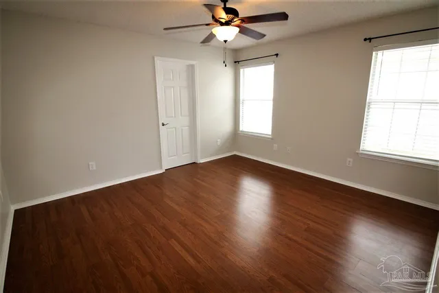 wooden floor in an empty room with a window