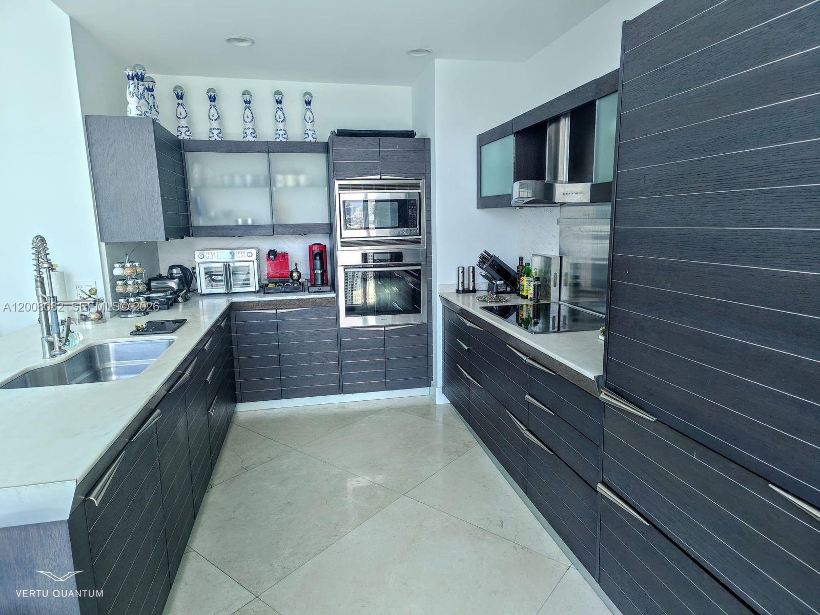 200 Biscayne Blvd Way, Unit 5001 Miami, FL 33131 - Photo 12 of 53 a large kitchen with stainless steel appliances and a sink