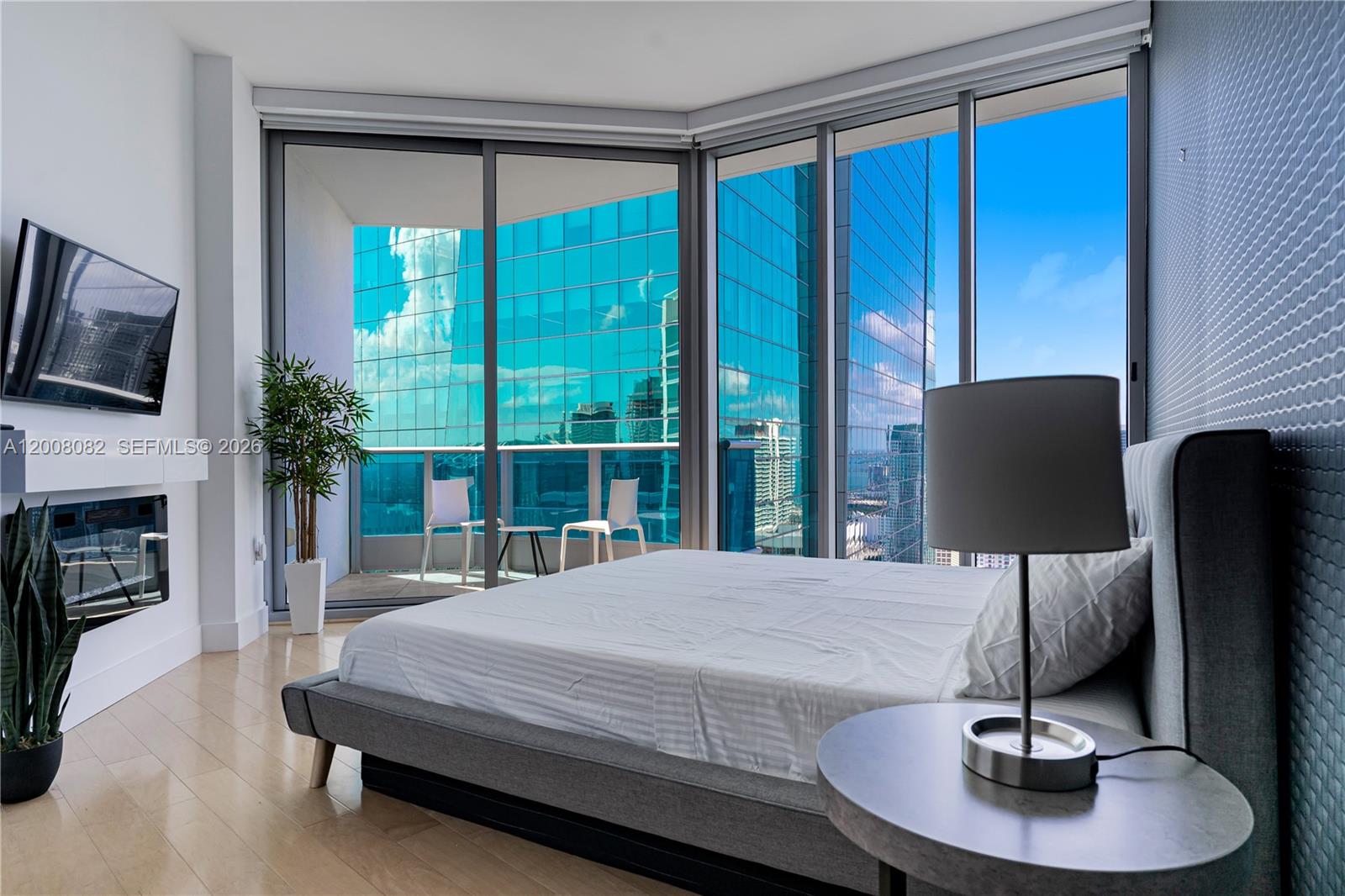 200 Biscayne Blvd Way, Unit 5001 Miami, FL 33131 - Photo 15 of 53 a bedroom with a large bed and a chandelier