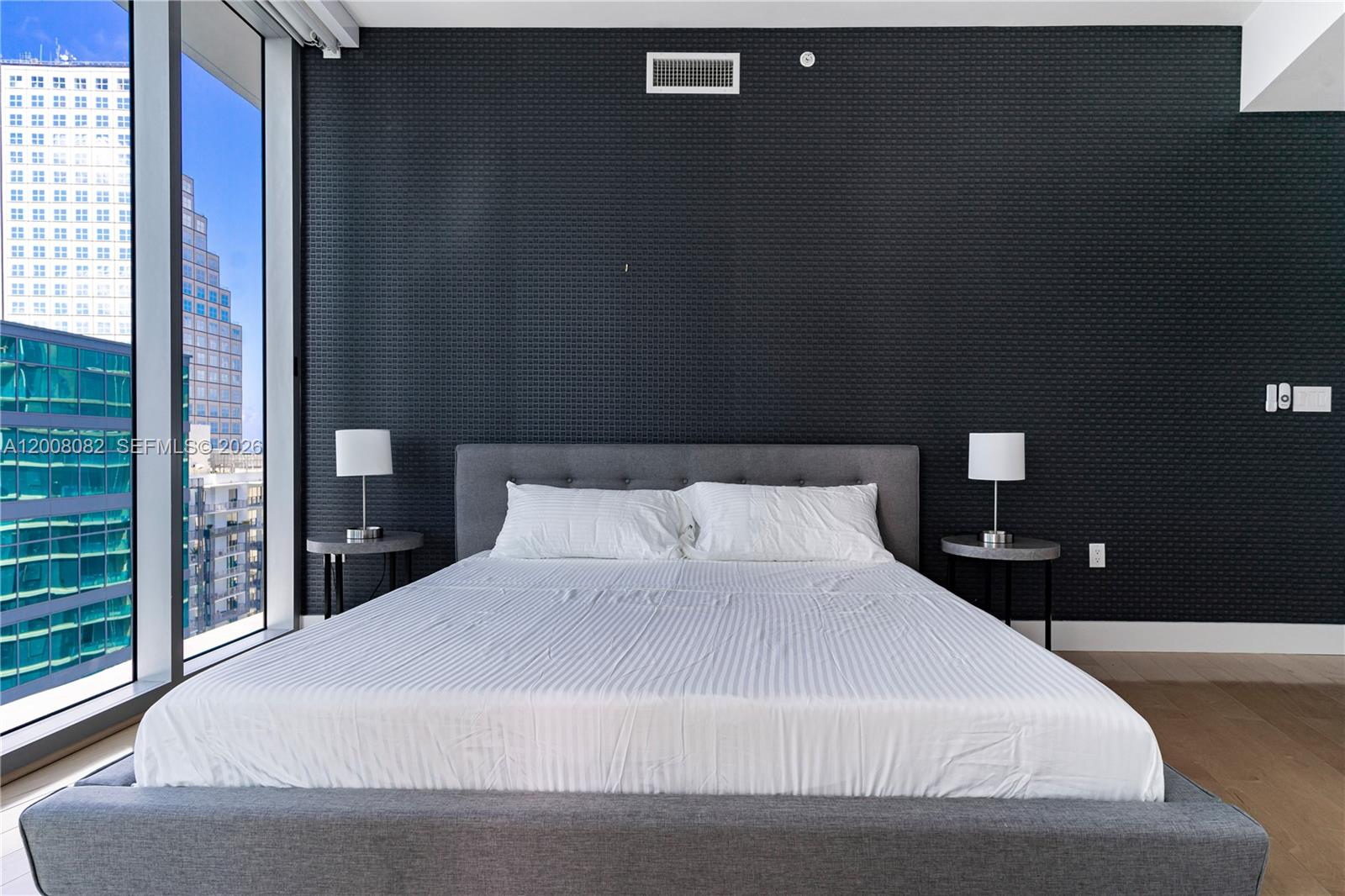 200 Biscayne Blvd Way, Unit 5001 Miami, FL 33131 - Photo 16 of 53 a large bed in a bedroom next to a window