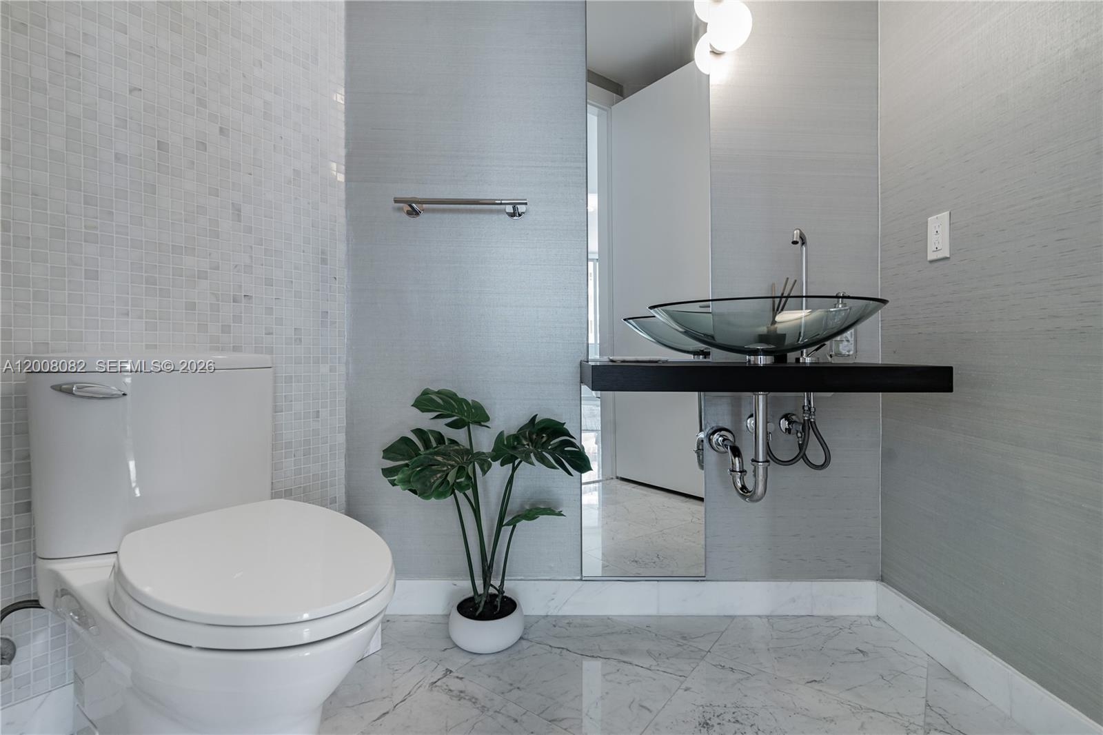 200 Biscayne Blvd Way, Unit 5001 Miami, FL 33131 - Photo 17 of 53 a bathroom with a toilet and a sink