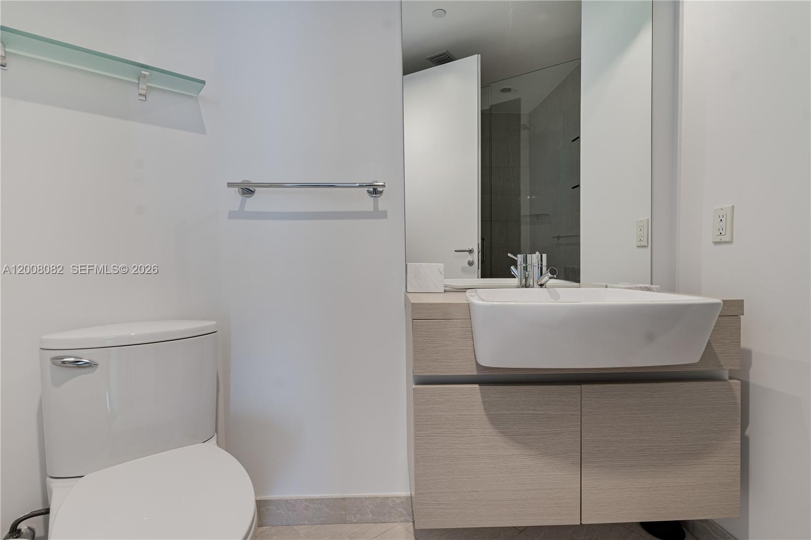 200 Biscayne Blvd Way, Unit 5001 Miami, FL 33131 - Photo 20 of 53 a bathroom with a sink toilet and mirror