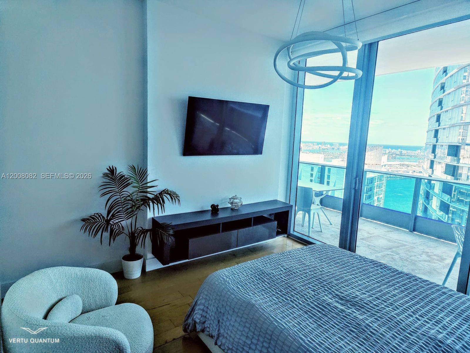 200 Biscayne Blvd Way, Unit 5001 Miami, FL 33131 - Photo 22 of 53 a bedroom with furniture and a large window