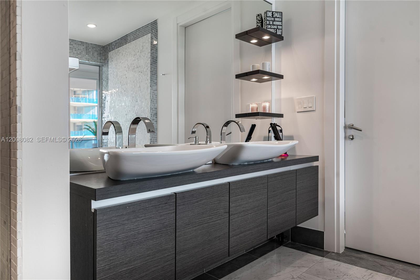 200 Biscayne Blvd Way, Unit 5001 Miami, FL 33131 - Photo 24 of 53 a bathroom with a double vanity sink and a mirror