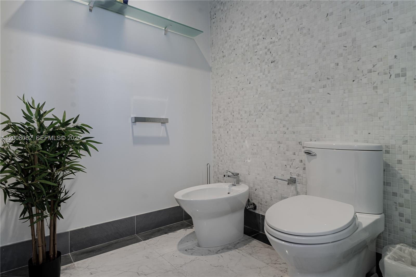 200 Biscayne Blvd Way, Unit 5001 Miami, FL 33131 - Photo 25 of 53 a bathroom with a toilet and a sink