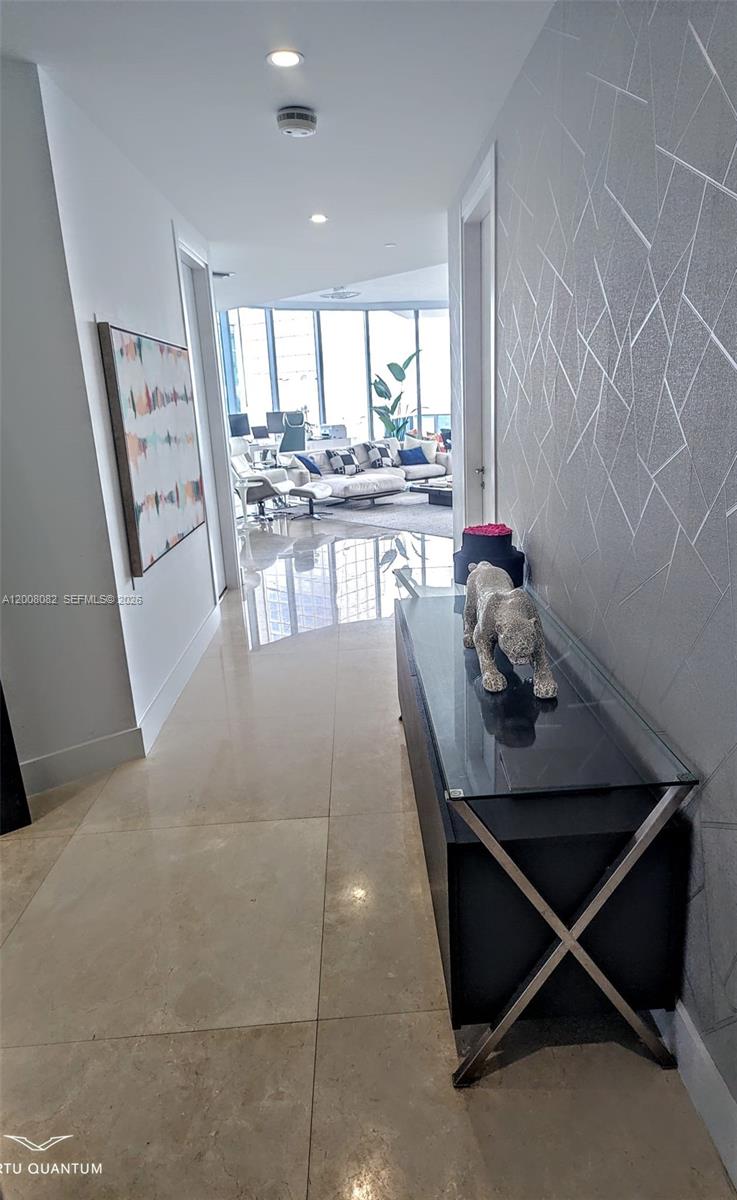 200 Biscayne Blvd Way, Unit 5001 Miami, FL 33131 - Photo 31 of 53 a living room with a table chairs and a kitchen view