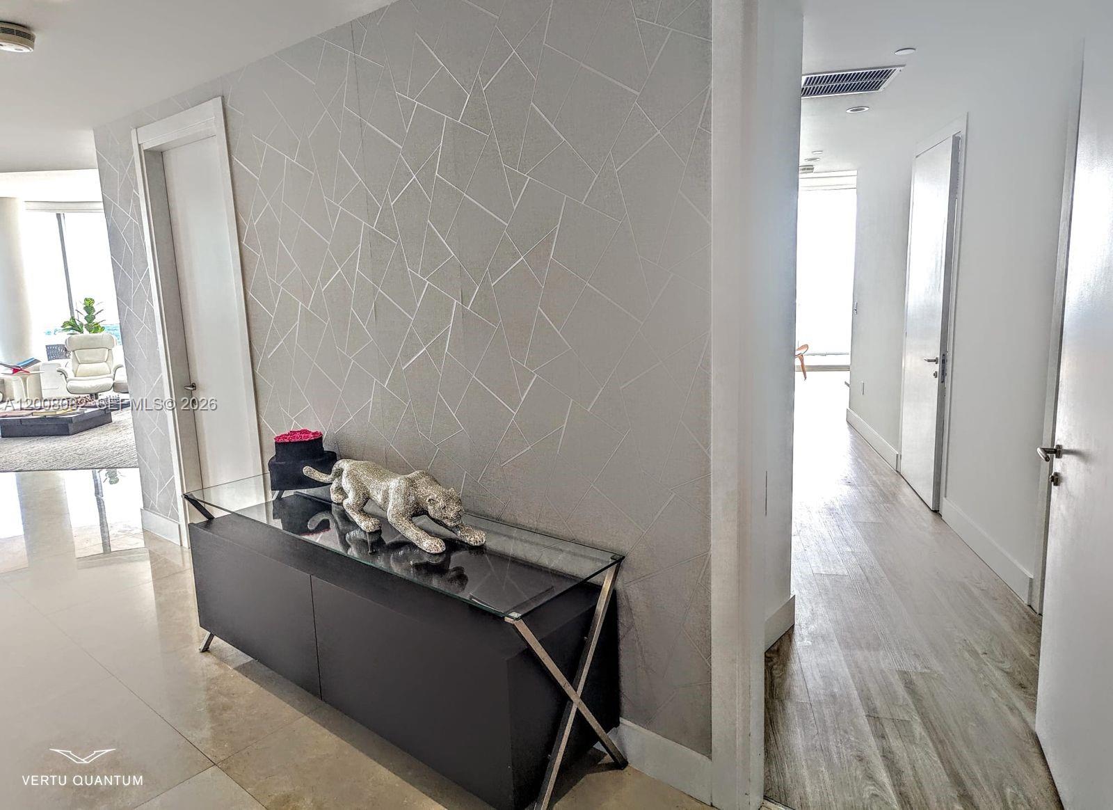 200 Biscayne Blvd Way, Unit 5001 Miami, FL 33131 - Photo 33 of 53 a room with wooden floor and furniture