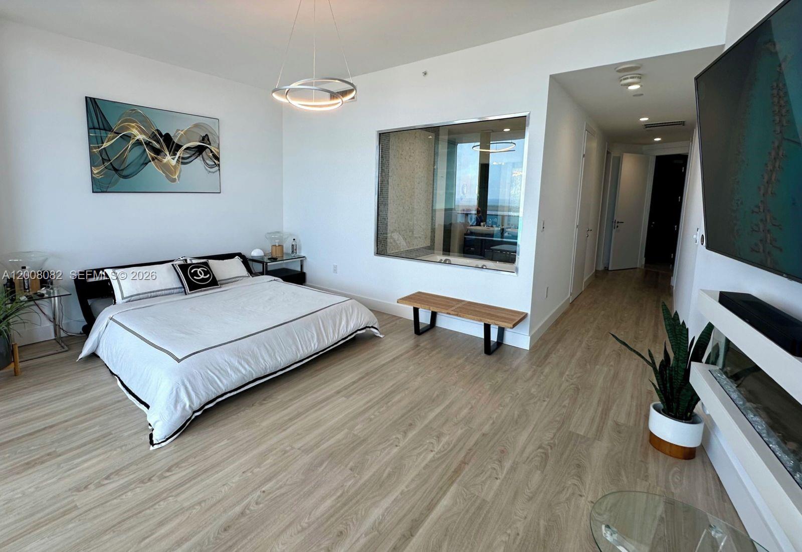 200 Biscayne Blvd Way, Unit 5001 Miami, FL 33131 - Photo 36 of 53 a bedroom with a bed and a desk