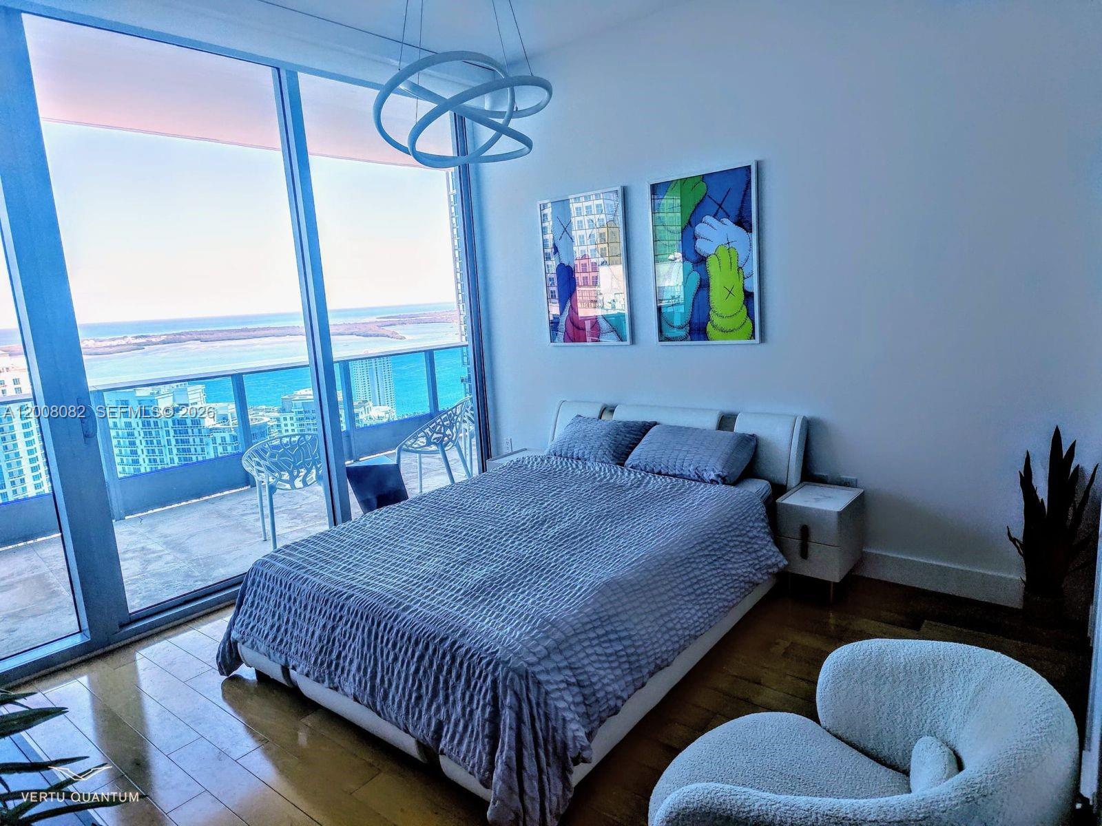 200 Biscayne Blvd Way, Unit 5001 Miami, FL 33131 - Photo 37 of 53 a bedroom with a bed and wooden floor