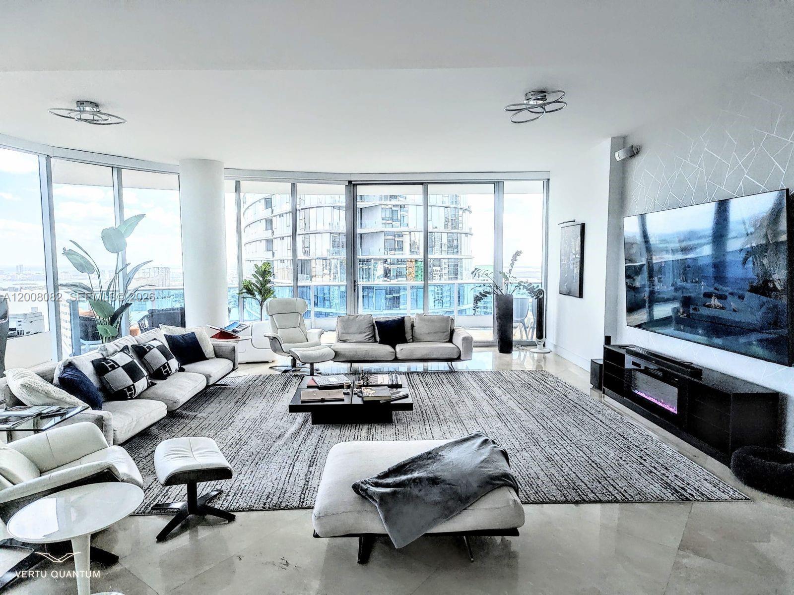 200 Biscayne Blvd Way, Unit 5001 Miami, FL 33131 - Photo 5 of 53 a living room with furniture and a large window