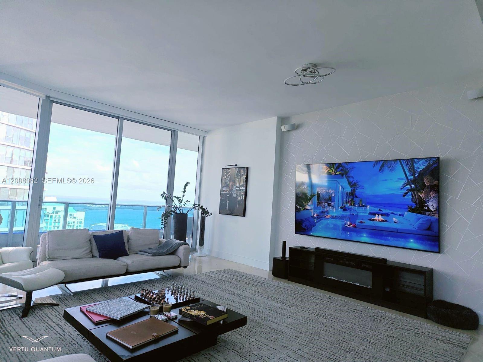 200 Biscayne Blvd Way, Unit 5001 Miami, FL 33131 - Photo 7 of 53 a living room with furniture and a floor to ceiling window