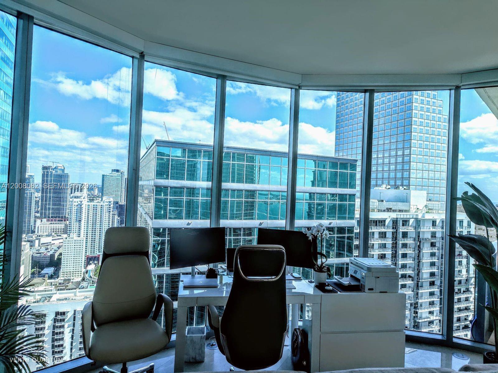 200 Biscayne Blvd Way, Unit 5001 Miami, FL 33131 - Photo 8 of 53 a view of a workspace with furniture and a large window